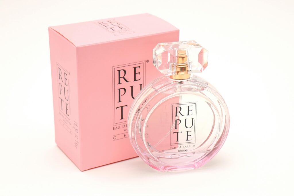 A stylish perfume bottle with pink box displaying elegant fragrance branding.
